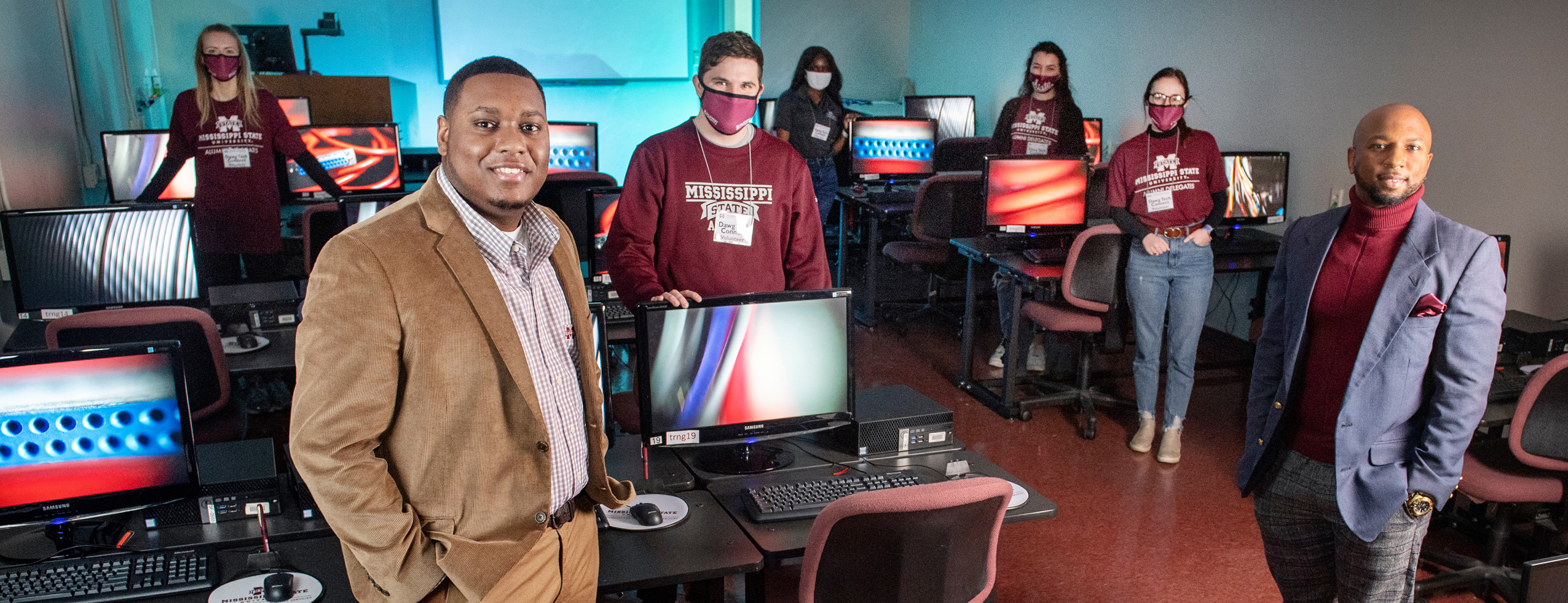 To help faculty adapt to new classroom technology, MSU’s Information Technology Services trained student volunteers from campus organizations to provide on-site support. ITS desktop services manager Ronald Gatewood (front right) said it was a win-win situation that kept classes on track and provided valuable customer-service experience to students like Taylor Ball (front left), an information technology services major whose success turned his volunteer position into a paid, part-time position.
